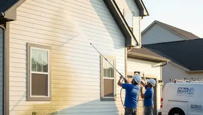 Durham, NC painters cleaning vinyl siding to remove pollen and grime for curb appeal
